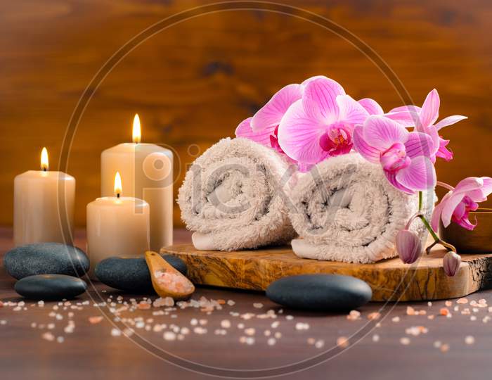 Black stone with candles for spa wooden background