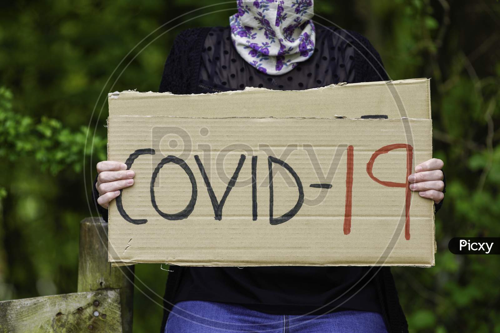 Young Women Holding Cardboard Sign Placard Covid-19