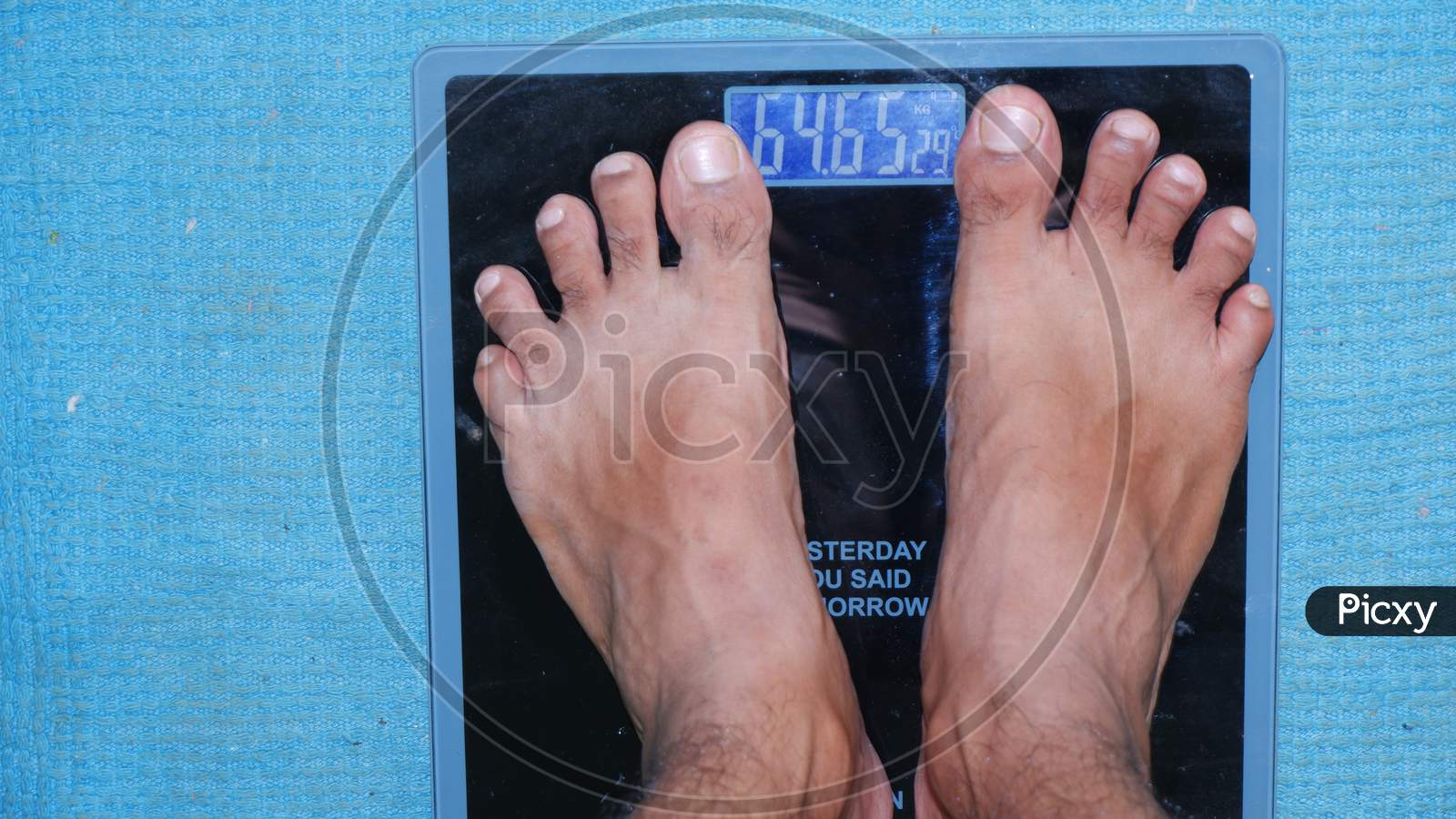 A MAN CHECKING HIS WEIGHT