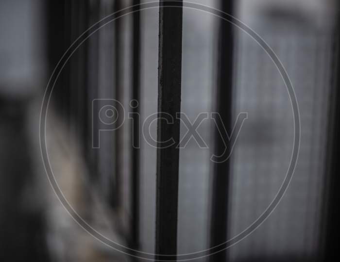 Grills/railings of a rooftop/balcony in cloudy sky background.