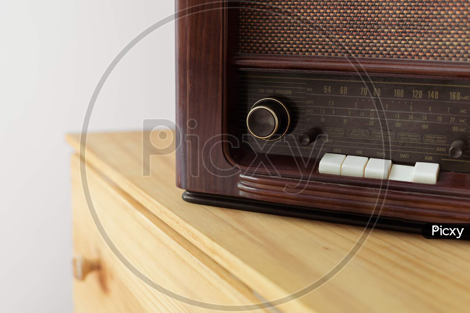Vintage radio made of wood and green vase on a old table