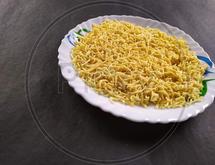 Indian tasty snacks on plate, Black background.