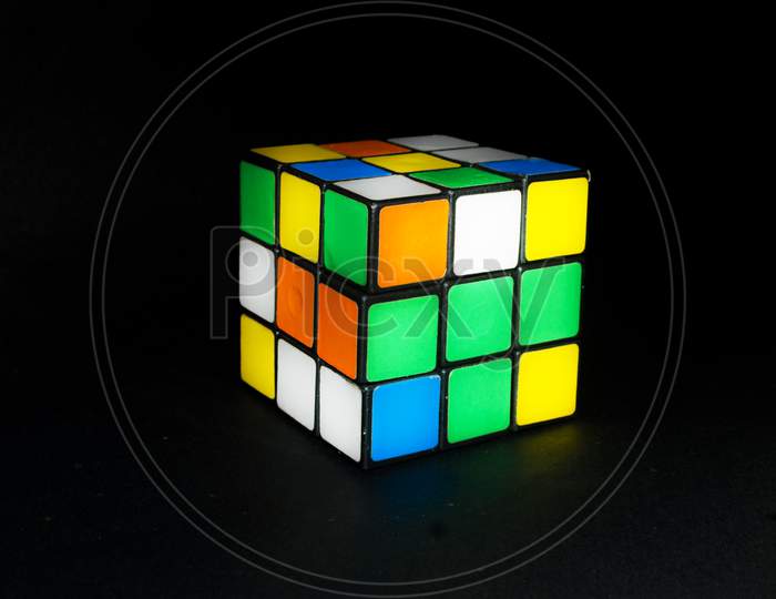 Rubik's cube 3D combination puzzle on an isolated black background
