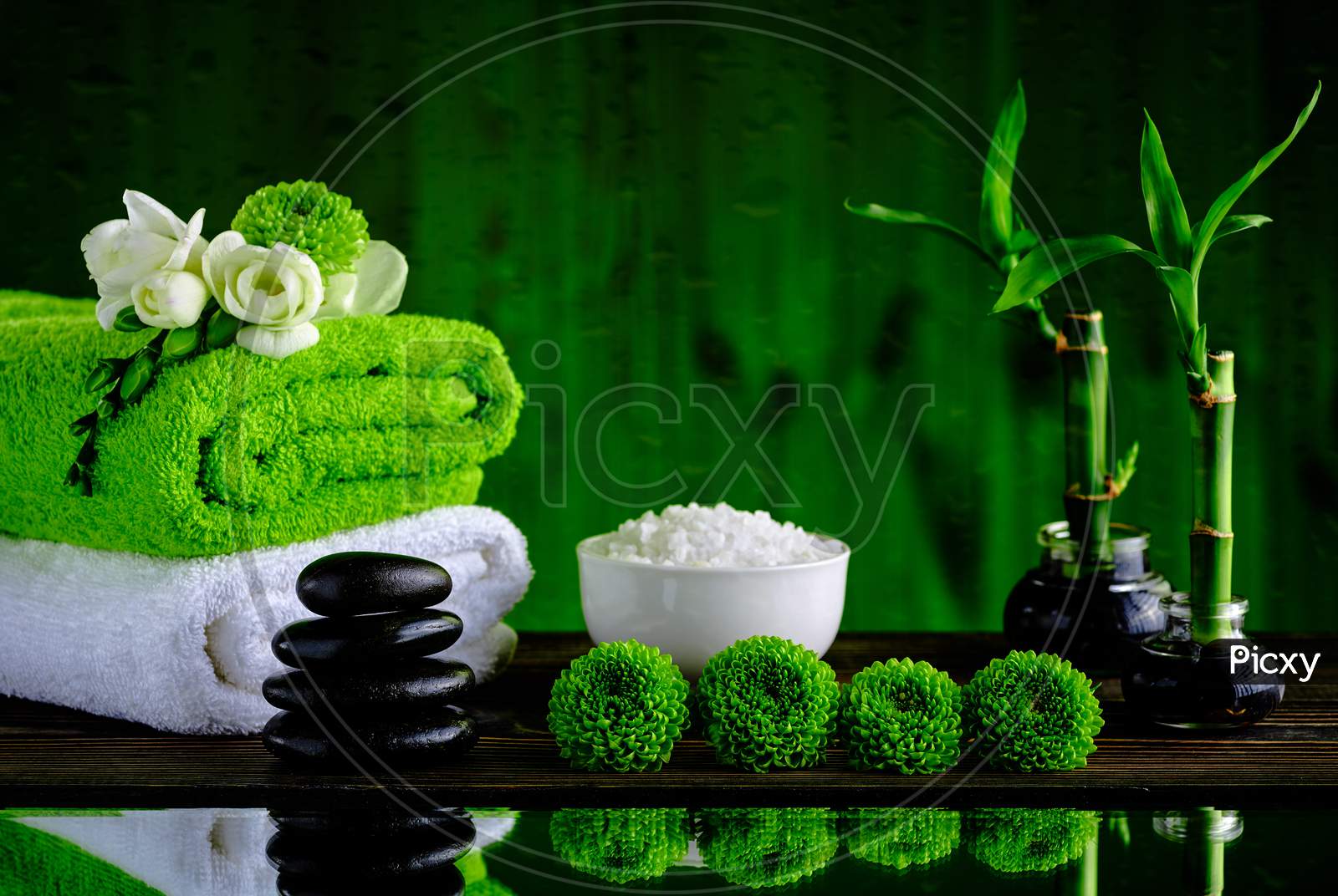 Green and white wall with black stone green background for spa