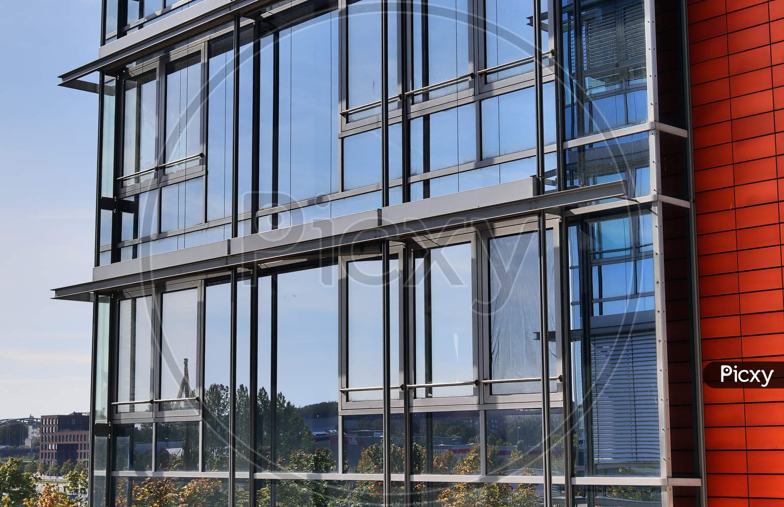 Modern office building facades with glass and reflecting sunlight in the windows found in kiel in germany