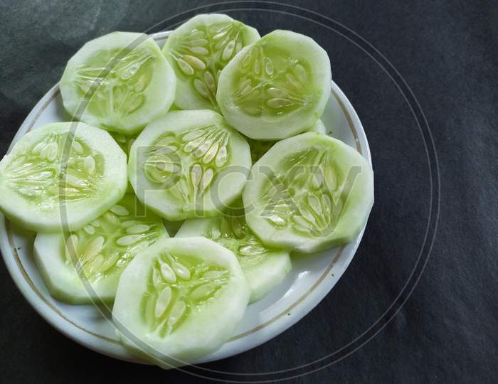 Cucumber salad on plate, Black background.