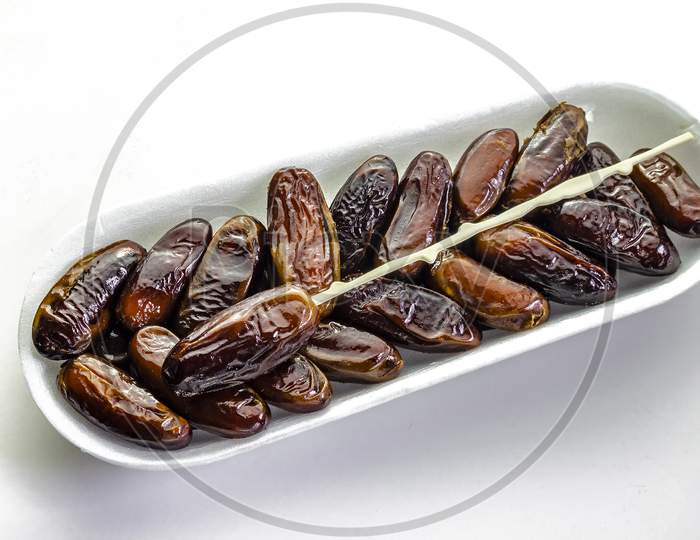 A tray of dates on a white background