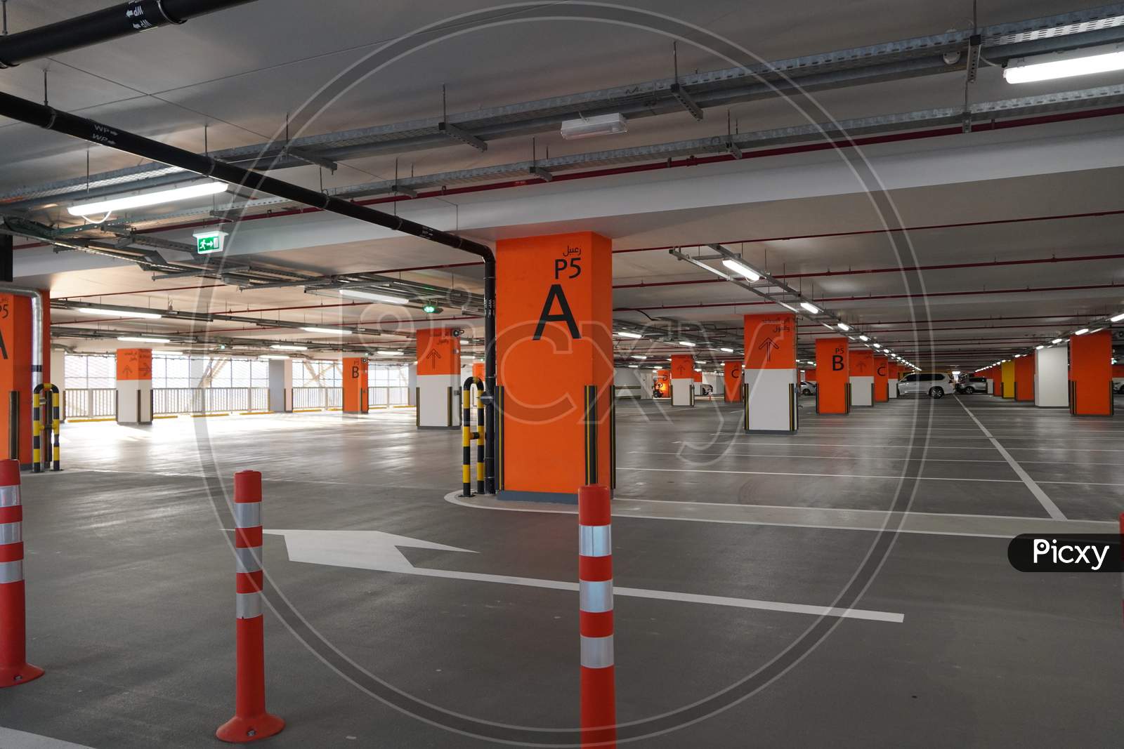 Dubai Uae December 2019 Underground Parking Which Is Almost Empty. Empty Garage In Basement Of Office Building. Reinforced Concrete Monolithic Floors In Basement. Urban, Industrial Background.