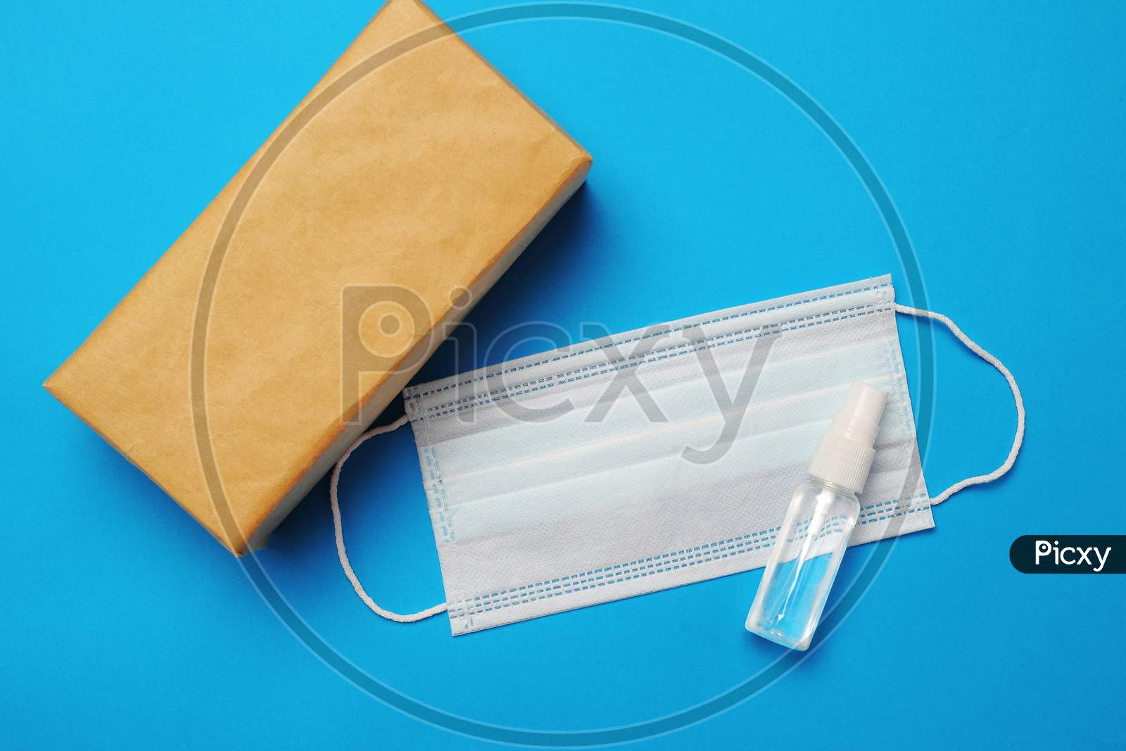 Brown Closed Carton Delivery Packaging Box ,Hand Sanitizer Spray And Surgical Facial Mask As Protection Against Influenza
