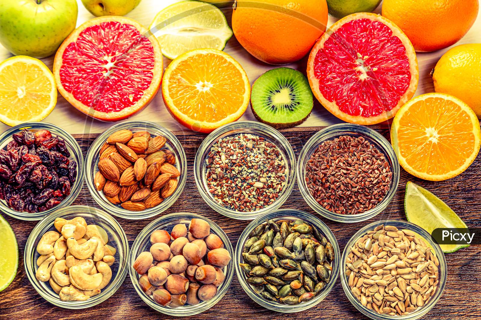 Assortment of colorful fresh fruits, nuts and seeds.