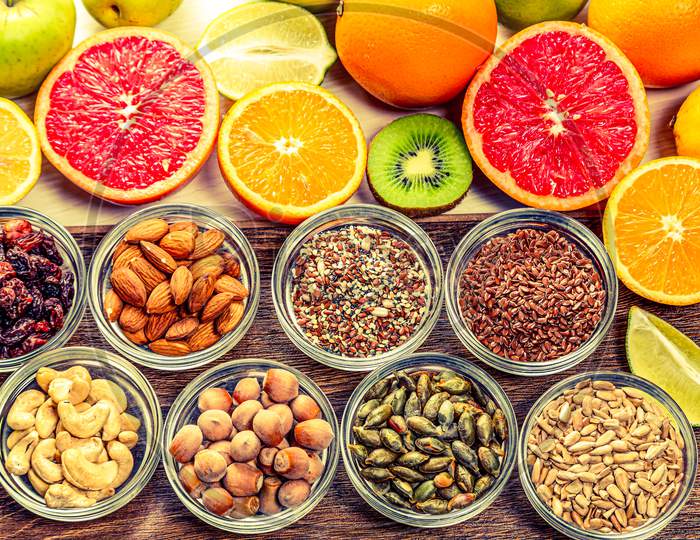 Assortment of colorful fresh fruits, nuts and seeds.