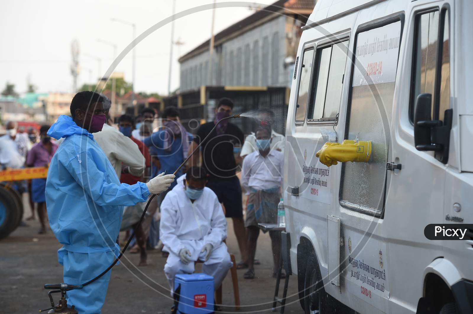 Medics Wearing Protective Suits Sanitise Their Hands After they Collect Swab Samples For Labourers Of Koyambedu Vegetable Market During A Government-Imposed Nationwide Lockdown As A Preventive Measure Against The Spread Of Covid-19 Or Coronavirus, In Chennai