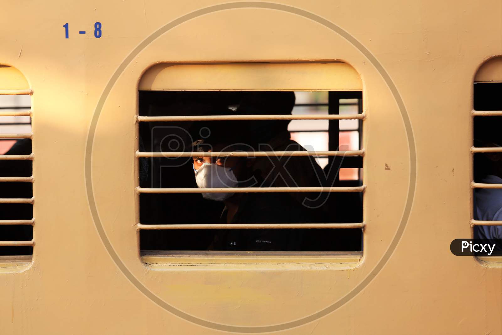 A man looks out of the window as he travels to Danapur, Bihar in a special train arranged by the government to repatriate migrant workers at the Chikkabanavara Junction Railway Station on the outskirts of Bangalore, India.