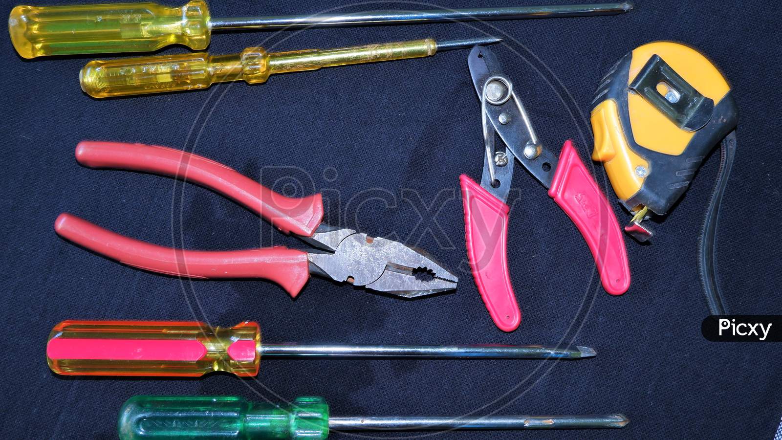 ASSORTED ELECTRICAL TOOLS ON BLACK BACKGROUND