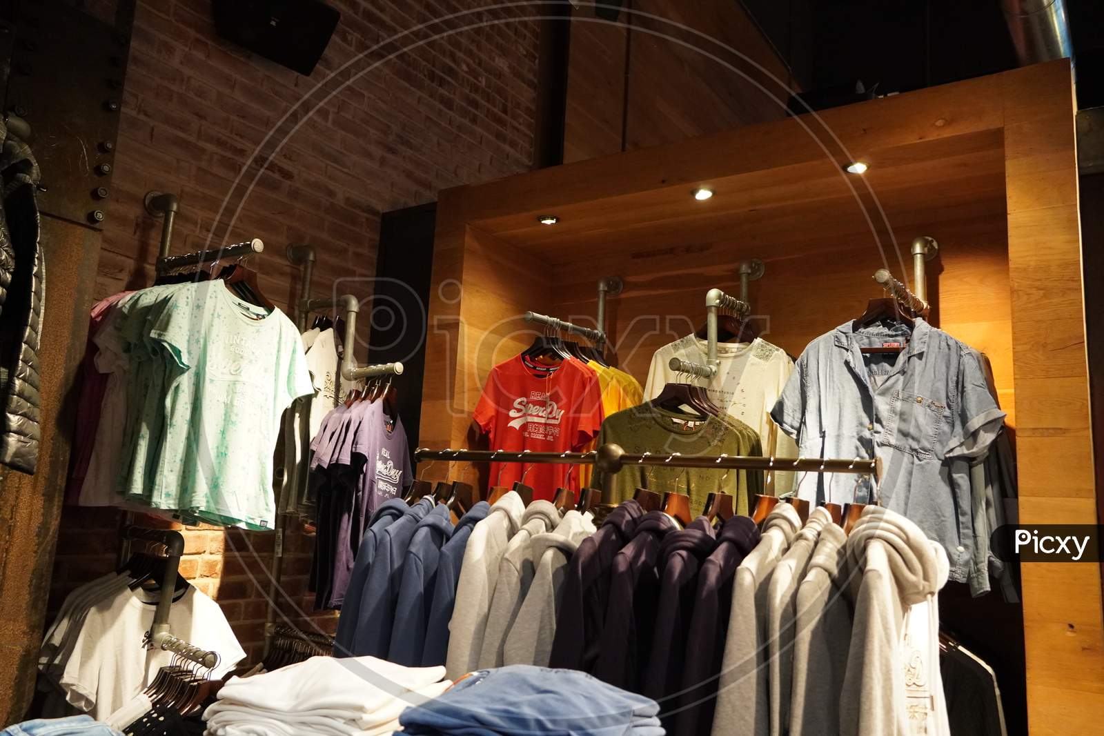 Image of Dubai Uae December 2019 Clothes Displayed For Sale Inside Clothing  Store. Interior View Of Super Dry Clothing Brand Retail Store. Inside View.  Jackets, Coats Shirts Etc.-AG373611-Picxy