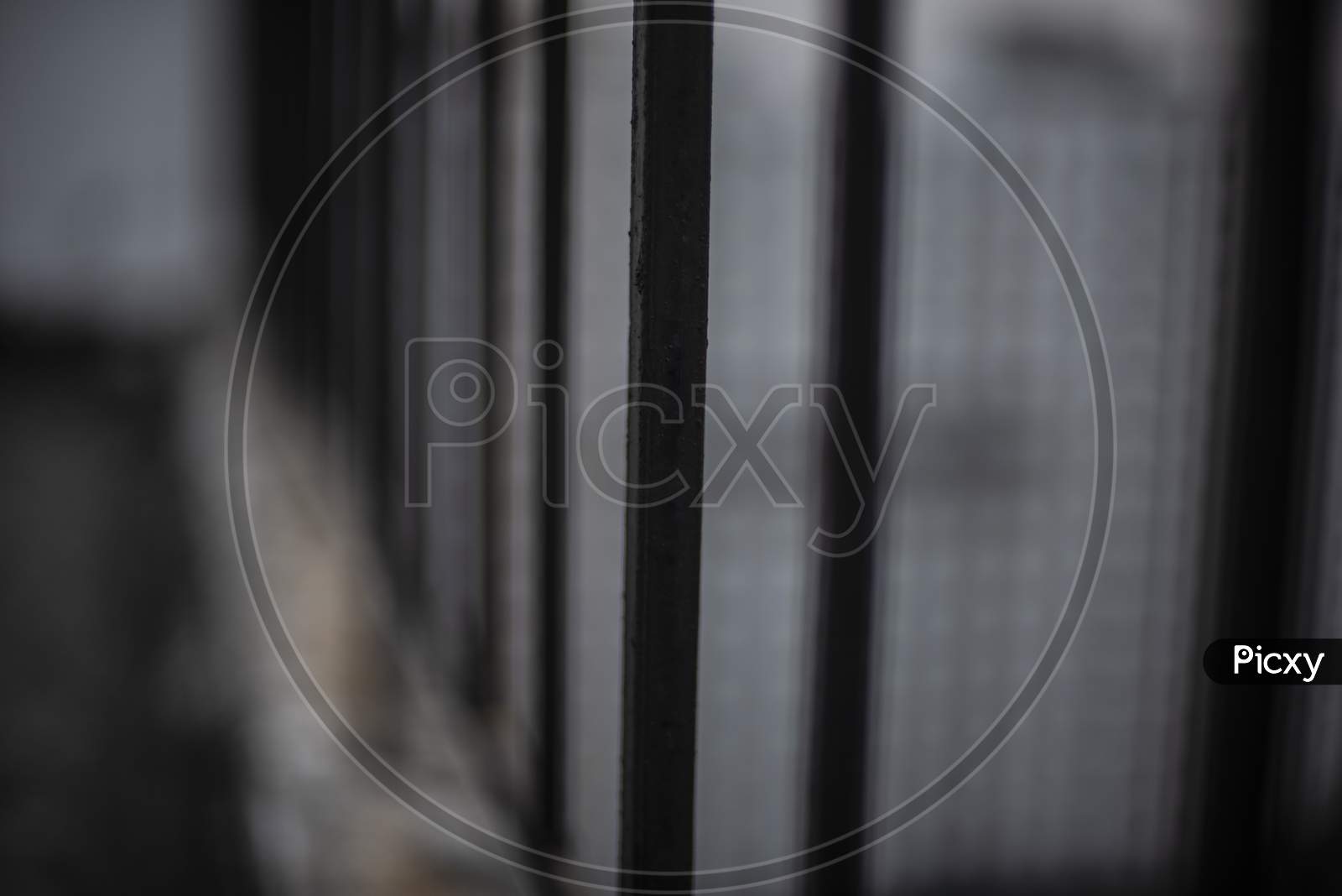 Grills/railings of a rooftop/balcony in cloudy sky background.