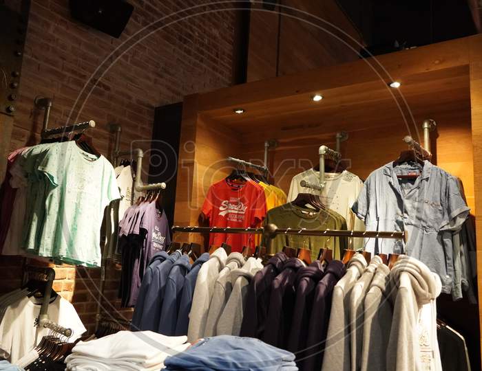 Dubai Uae December 2019 Clothes Displayed For Sale Inside Clothing Store. Interior View Of Super Dry Clothing Brand Retail Store. Inside View. Jackets, Coats Shirts Etc.
