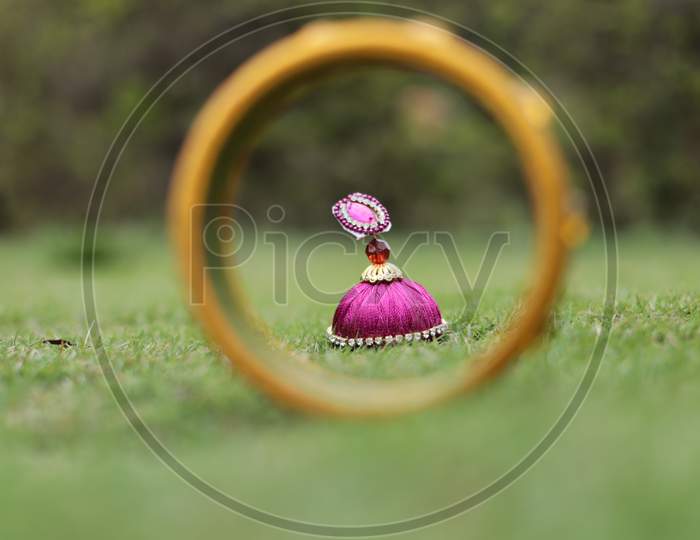 Handmade Colourful Earrings On Green Lawn Grass Background