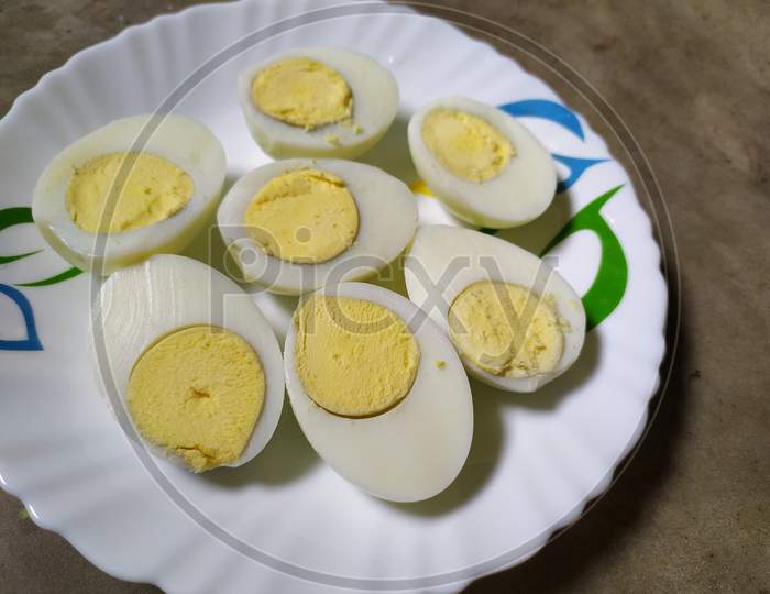 Boiled eggs on plate, Black background.