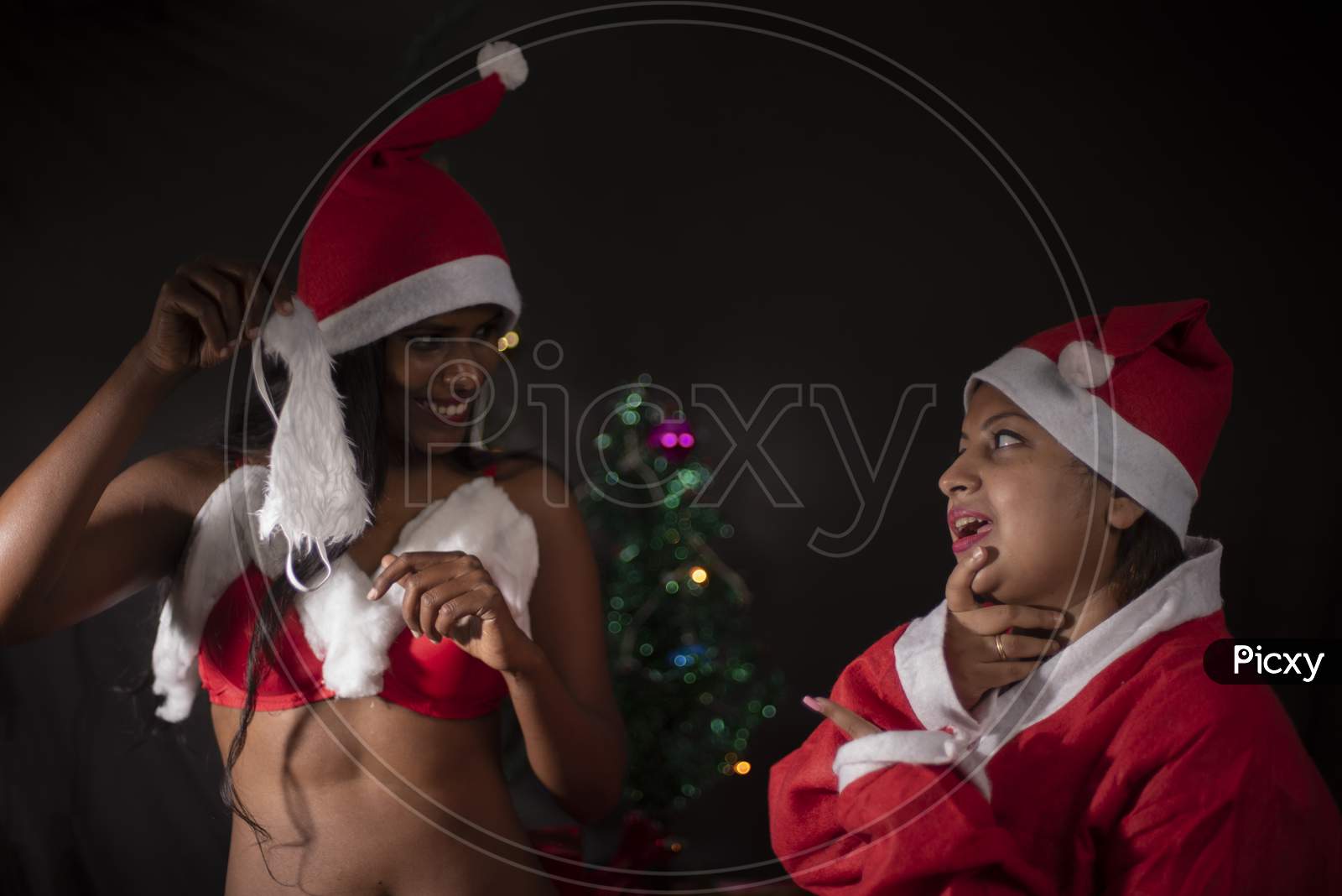 Image of Young Indian Bengali woman wearing Santa Clause lingerie