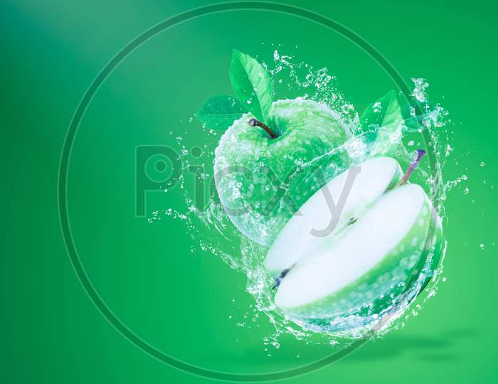 green apple with leaf and water