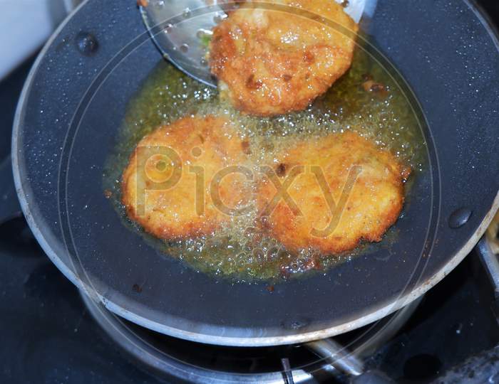 cutlets frying  in a pan