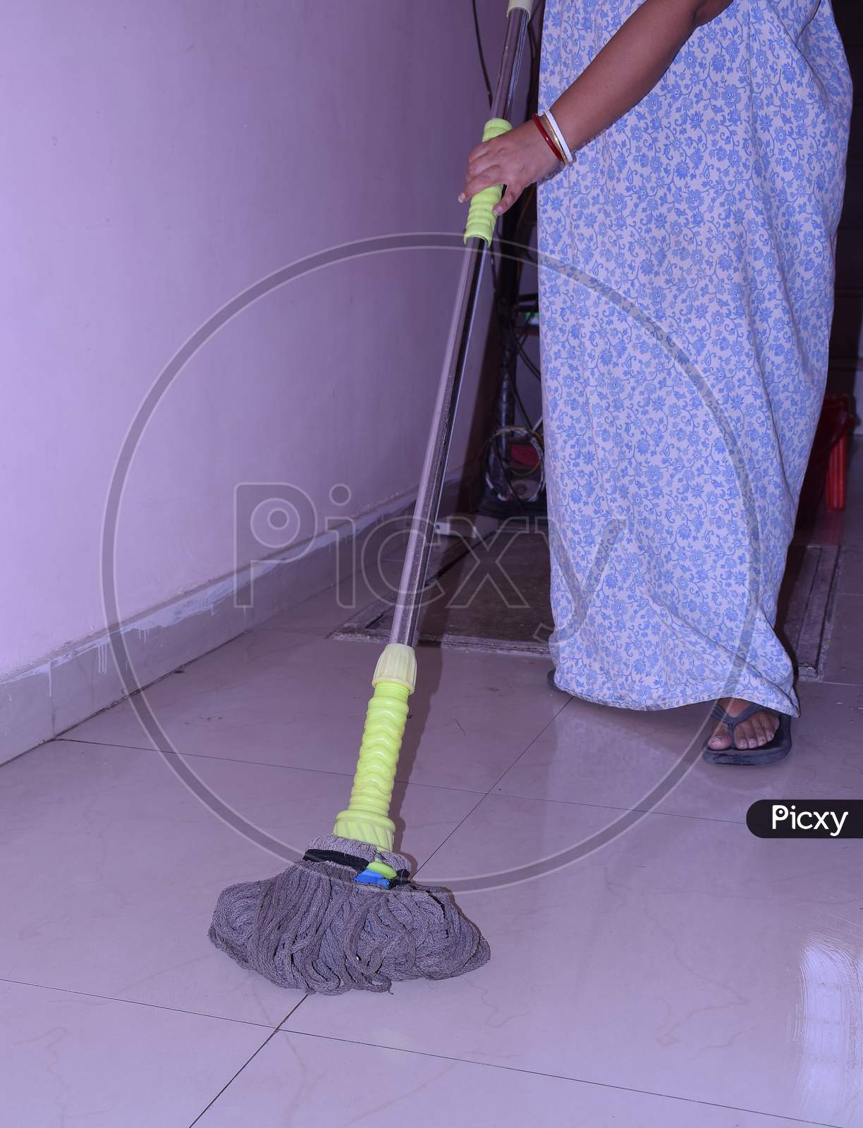 A cleaner mopping the floor