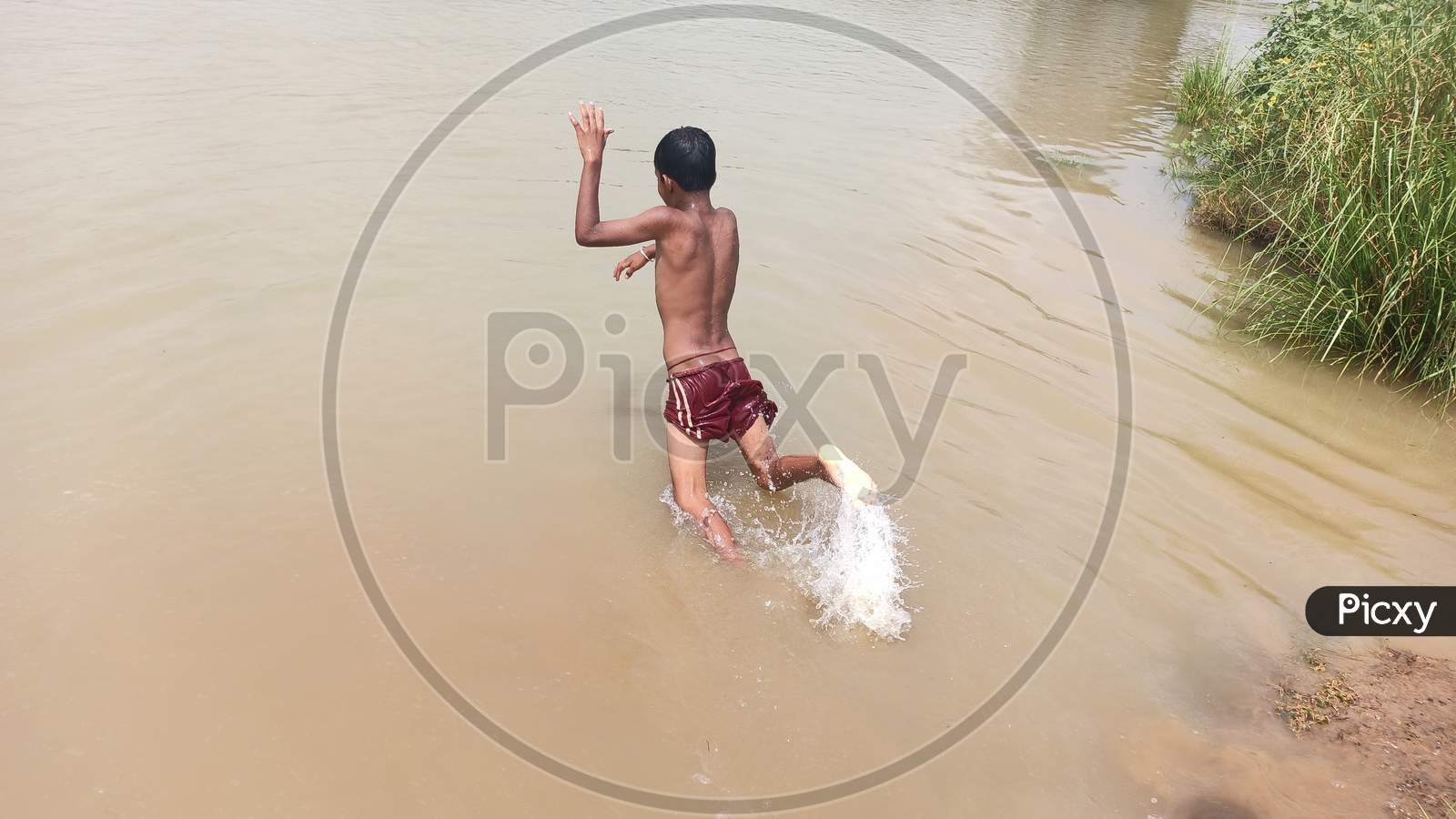 A boy jumping on pond