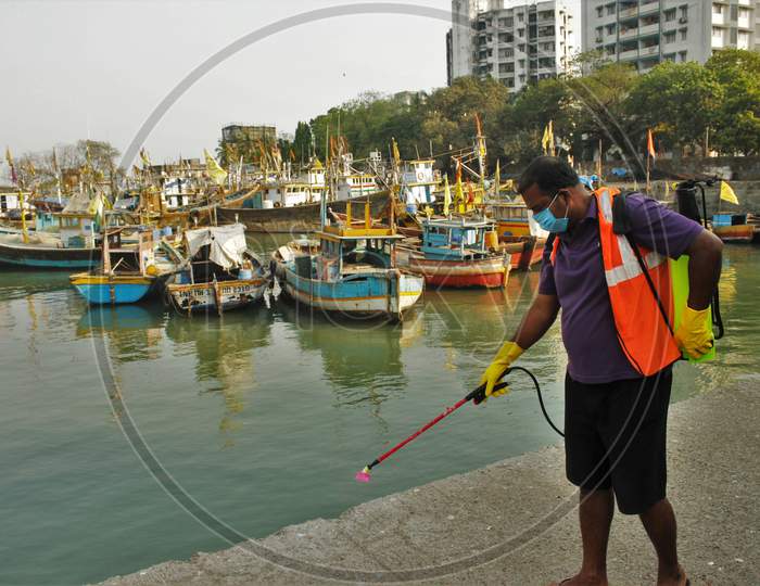 A worker sprays disinfectant at a deserted fish market after the extension of the 21- day nationwide lockdown to limit the spreading of coronavirus disease (COVID-19) in Mumbai, India, on April 15, 2020.