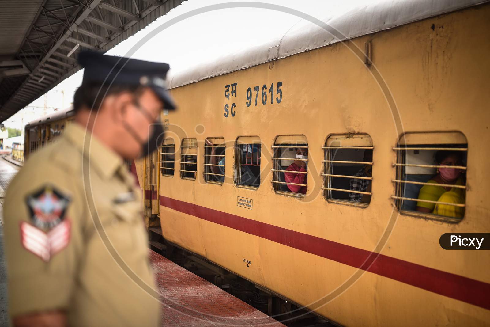 Passengers board a train to Secunderabad at Vijayawada Railway station as Indian Railways resumes train services, in Vijayawada.