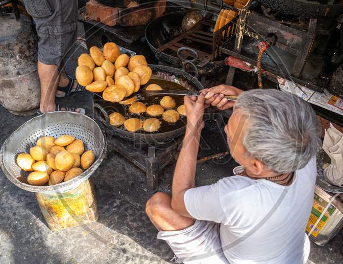 A man preparing kachori at a shop in jaipur, march 2019