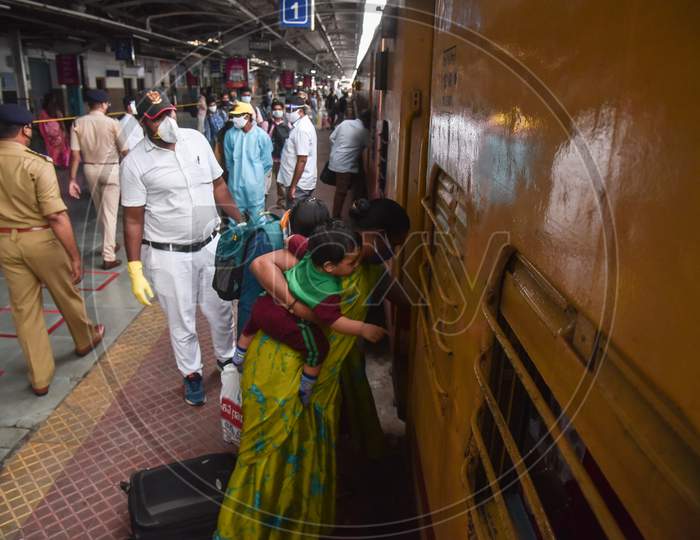 Passengers board a train to Secunderabad at Vijayawada Railway station as Indian Railways resumes train services, in Vijayawada.