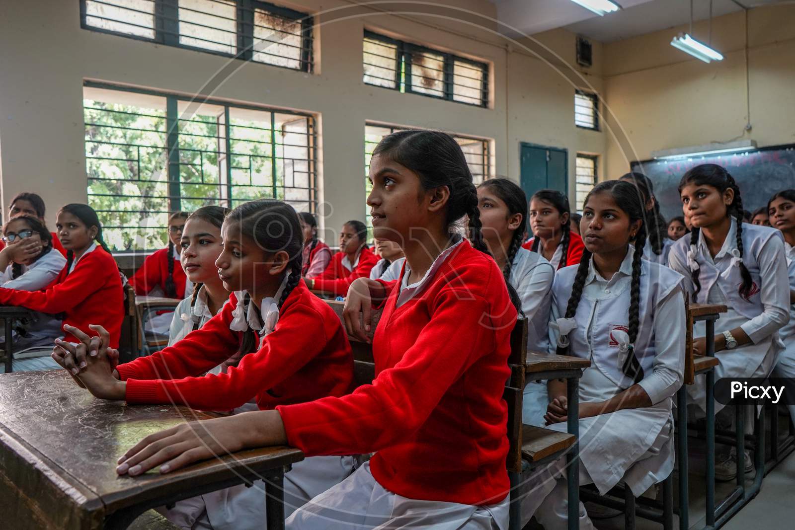 Image of New Delhi, Delhi/ India- June 1 2020: Girls Of Government School  Wearing Red Uniform, Meditating Before The Class Starts.-BH786363-Picxy