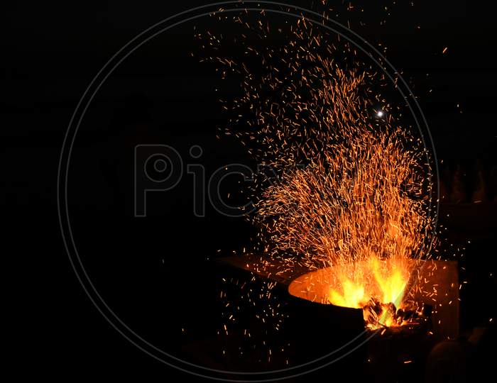 Amazing Sparks in the Dark. Beautiful abstract background on the theme of fire, light and life. Sparks fly in the sky