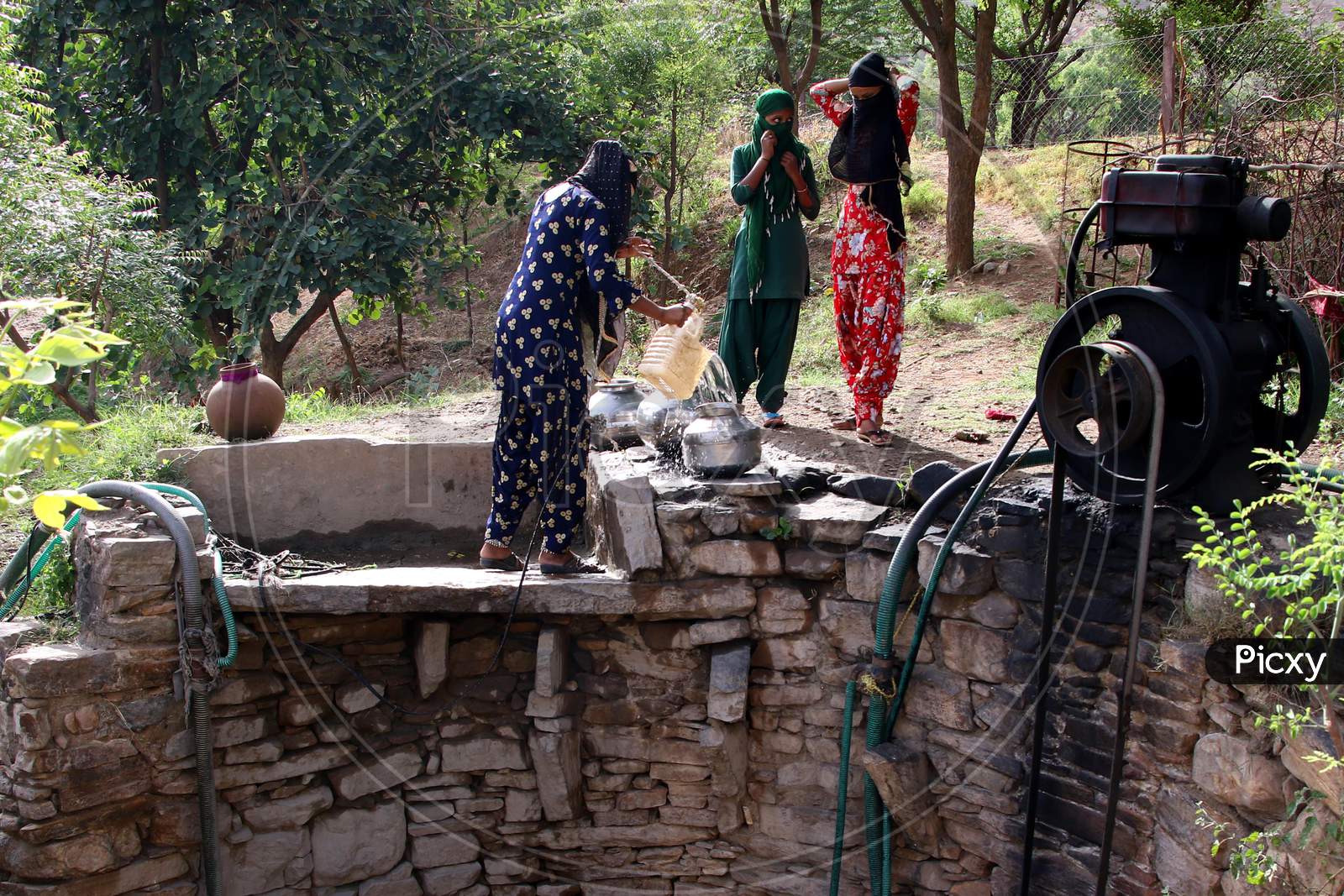 People Fetch Drinking Water From A Well During Hot Summer Day On The Outskirts Of Ajmer, Rajasthan, India.