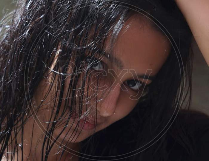 Closeup of young fascinating girl with wet hairs