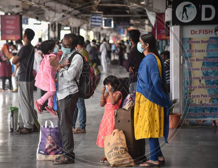 Passengers wait to board a train to Secunderabad at Vijayawada Railway station as Indian Railways resumes train services, in Vijayawada.