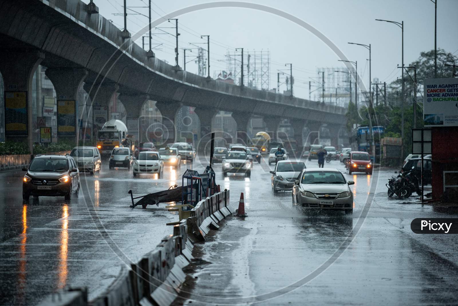 Vehicles ply as Heavy rains and gusty winds lash several parts of the city as the government eases lockdown restrictions amid coronavirus pandemic, May 31, 2020, KPHb,Hyderabad.