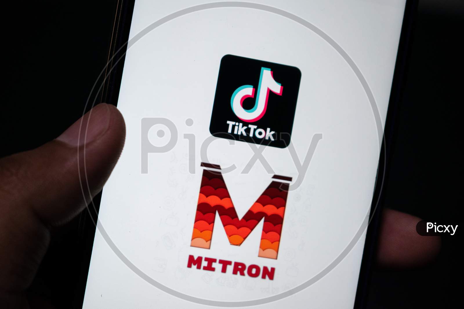 Mitron application and Chinese application tiktok logo on a phone. Both applications are video content creation applications