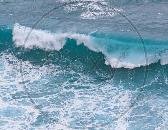 Blue And White Breaking Ocean Wave Seen From Above