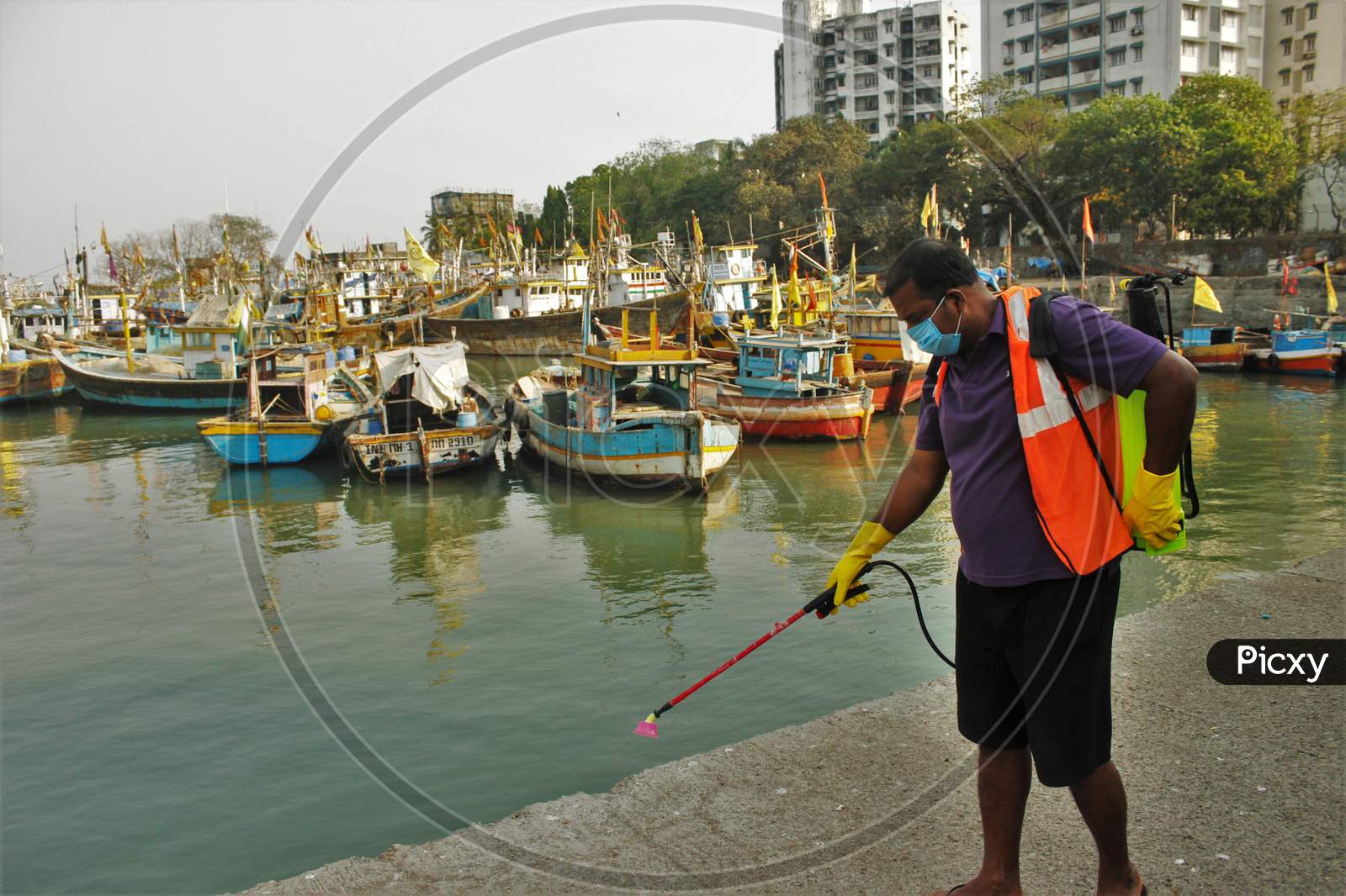 A worker sprays disinfectant at a deserted fish market after the extension of the 21- day nationwide lockdown to limit the spreading of coronavirus disease (COVID-19) in Mumbai, India, on April 15, 2020.