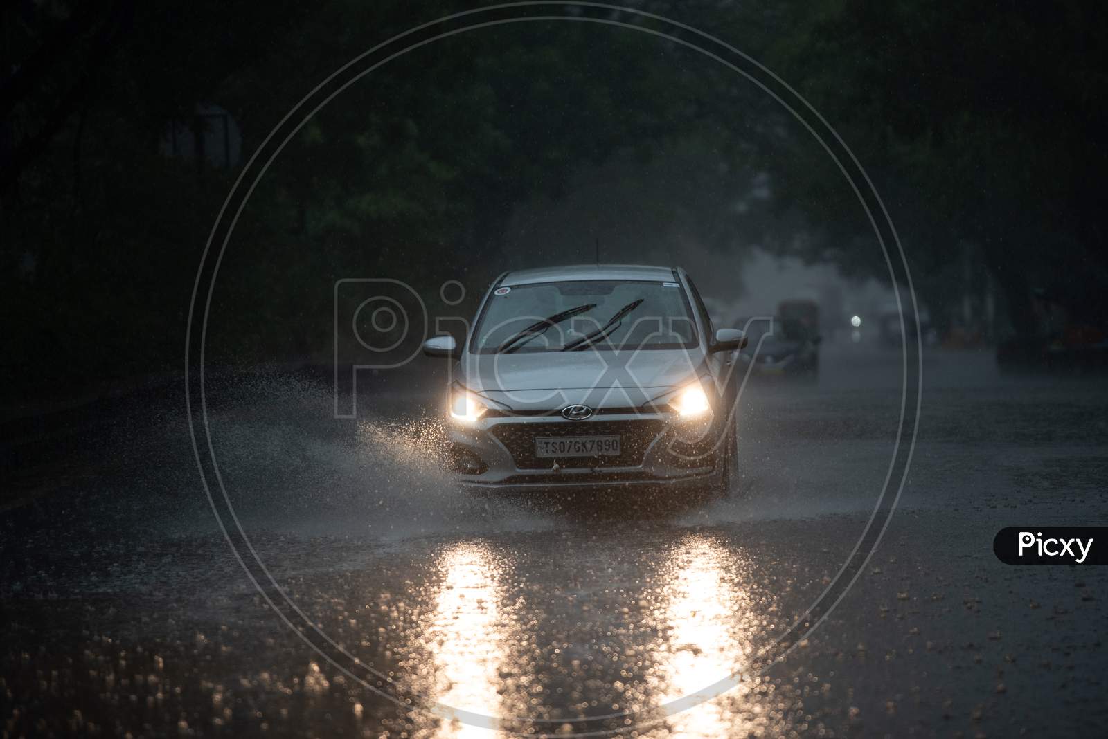 Vehicles ply on KPHB Main road as rain lashes heavily along with gusty winds on May 31, 2020, Hyderabad
