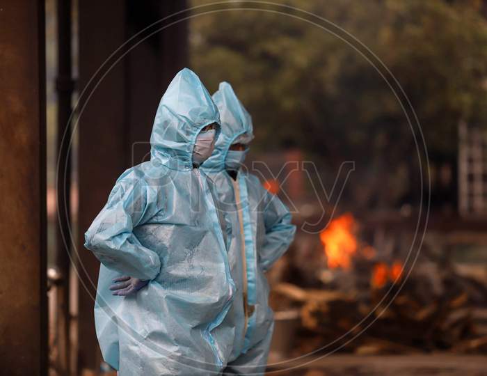 Relatives Of The Deceased Covid-19 patient Wear Hazmat Suits to Perform The Last Rites At Nigambodh Ghat, On May 31, 2020 In New Delhi, India.