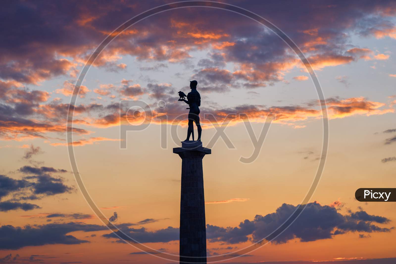Silhouette of Victor monument with colorful sunset in the background, Belgrade