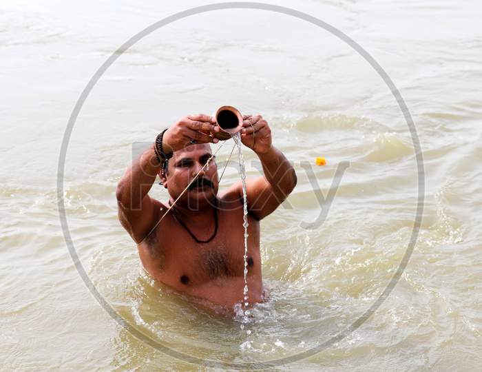 Hindu Devotees Offering  Prayers To Holy River Ganga After Taking Holy Dip in Triveni Sangam Of Three Rivers, The Ganga, The Yamuna And Mythical Saraswati On The Occasion Of Ganga Dusshera Festival In Prayagraj, June 1, 2020.