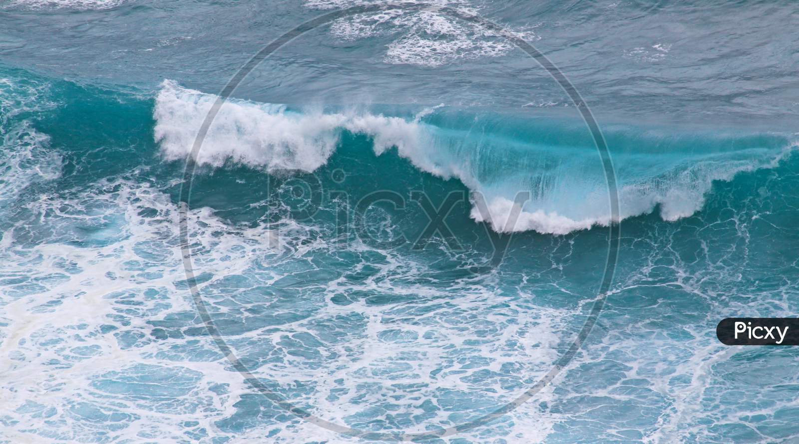 Blue And White Breaking Ocean Wave Seen From Above