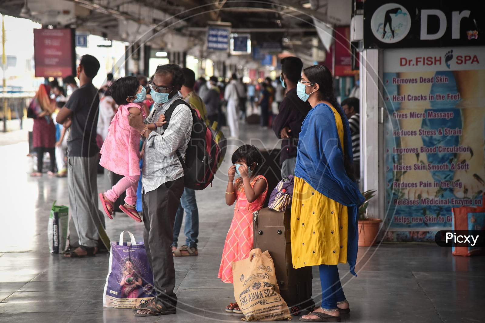 Passengers wait to board a train to Secunderabad at Vijayawada Railway station as Indian Railways resumes train services, in Vijayawada.