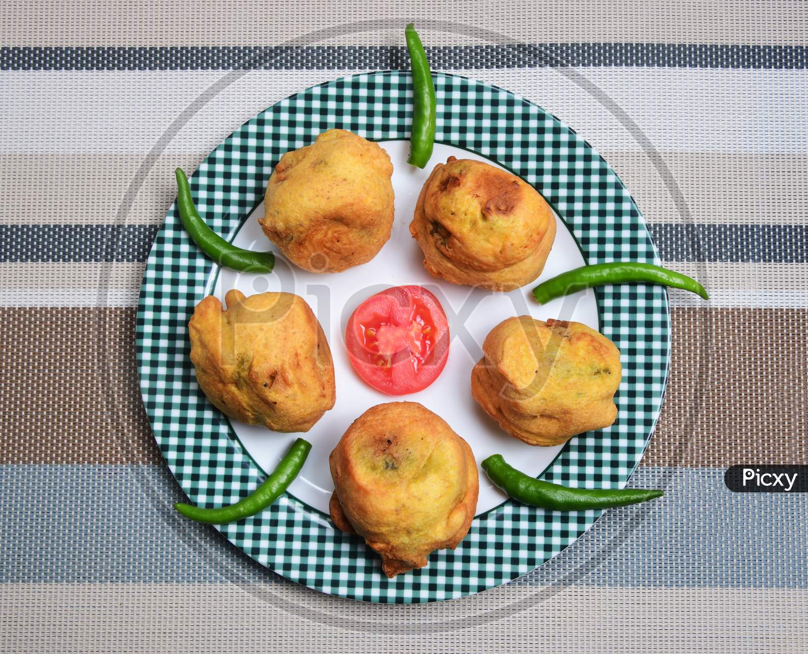 Mashed potato balls coated with chickpea flour and lightly fried. Vada Pav.