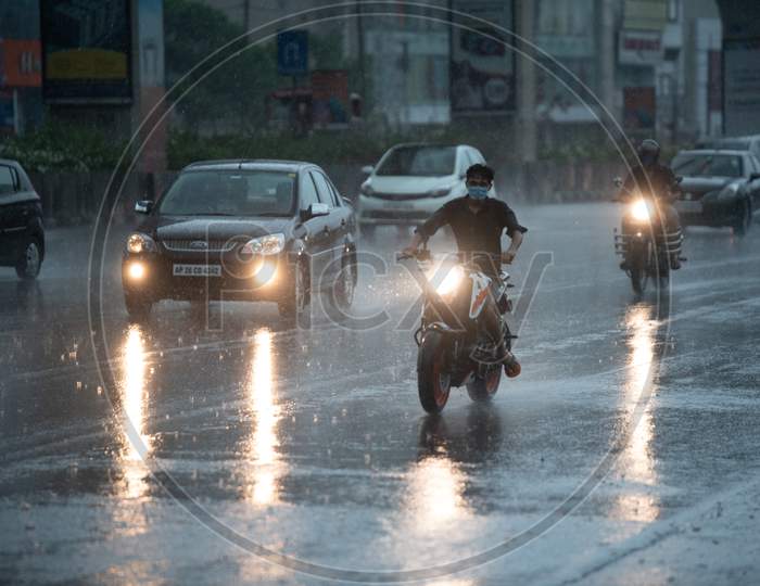 Vehicles ply as Heavy rains and gusty winds lash several parts of the city as the government eases lockdown restrictions amid coronavirus pandemic, May 31, 2020, KPHb,Hyderabad.
