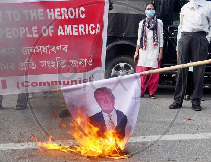 Activists Of Socialist Unity Centre Of India (Communist) Burning The Poster Of Donald John Trump, President Of The United States During The Protest Demonstration against the killing in USA, In Guwahati, On June 1, 2020